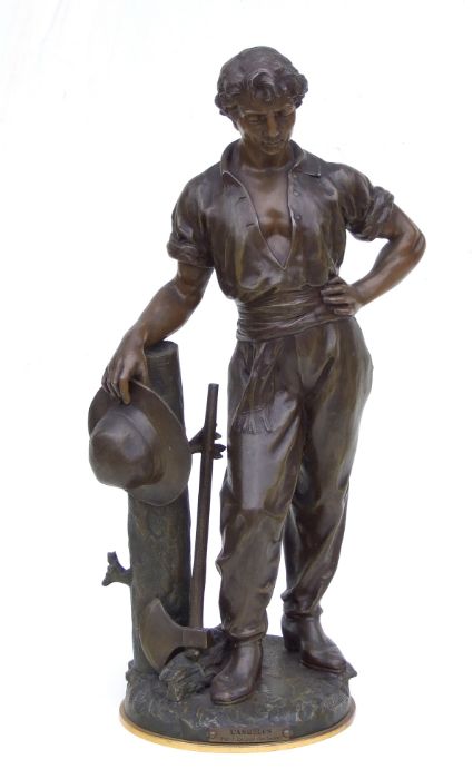 A large late 19th century bronzed spelter figure of a woodsman holding a hat and standing next to