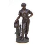 A large late 19th century bronzed spelter figure of a woodsman holding a hat and standing next to