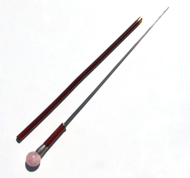 A Malacca sword stick with pink quartz ball handle and white metal collar, with a triangular
