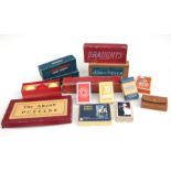 A collection of vintage board games and playing cards including, the ARJAY Compendium of puzzles,