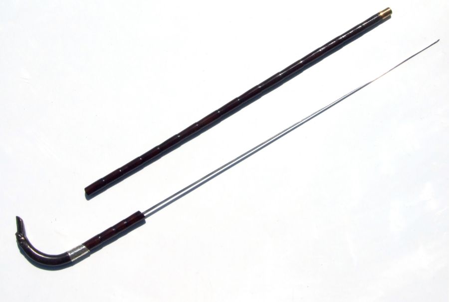 A partridge wood sword stick with bronze greyhound head handle and white metal collar, and square
