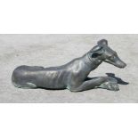 A bronzed stoneware figure of a recumbent greyhound, 60cm long together with two stoneware green man