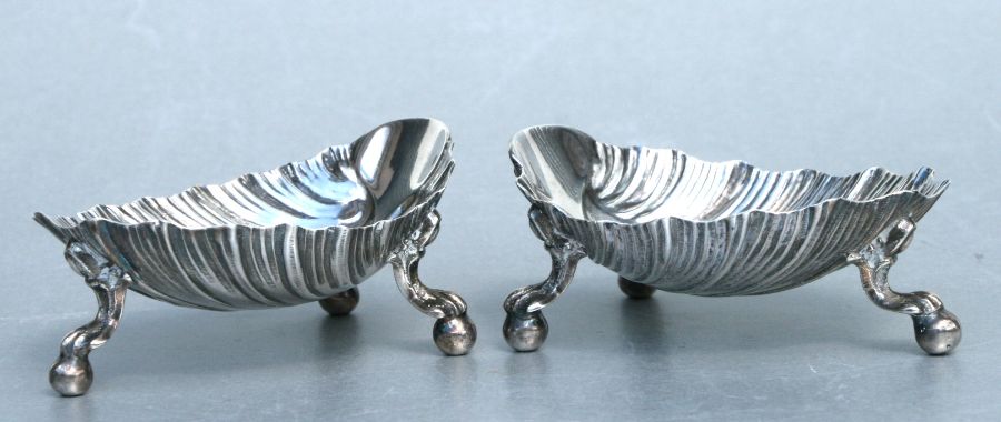 A pair of Victorian silver shell shaped salts stand on ball and claw feet, Sheffield 1870. Each