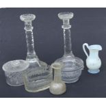 A pair of early 19th century cut glass candlesticks with faceted columns, 27cms high; together