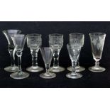 A quantity of 18th century glasses to include a set of three with etched bowls depicting birds and