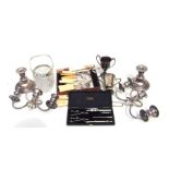 A quantity of silver plated items to include candlesticks, trophy, a gravy boat and flatware.