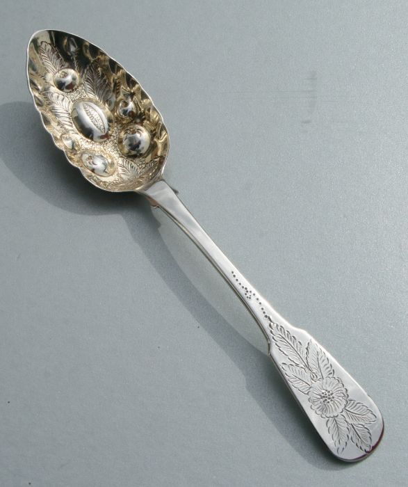 A George III Scottish silver fiddle pattern berry spoon, the gilt bowl with repousse decoration