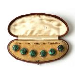 A set of six Victorian green mottled enamel and yellow metal buttons in a fitted leather case.