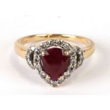 An 18ct gold diamond and pear cut ruby ring, ruby approx 1.30ct and 24 brilliant cut diamonds approx
