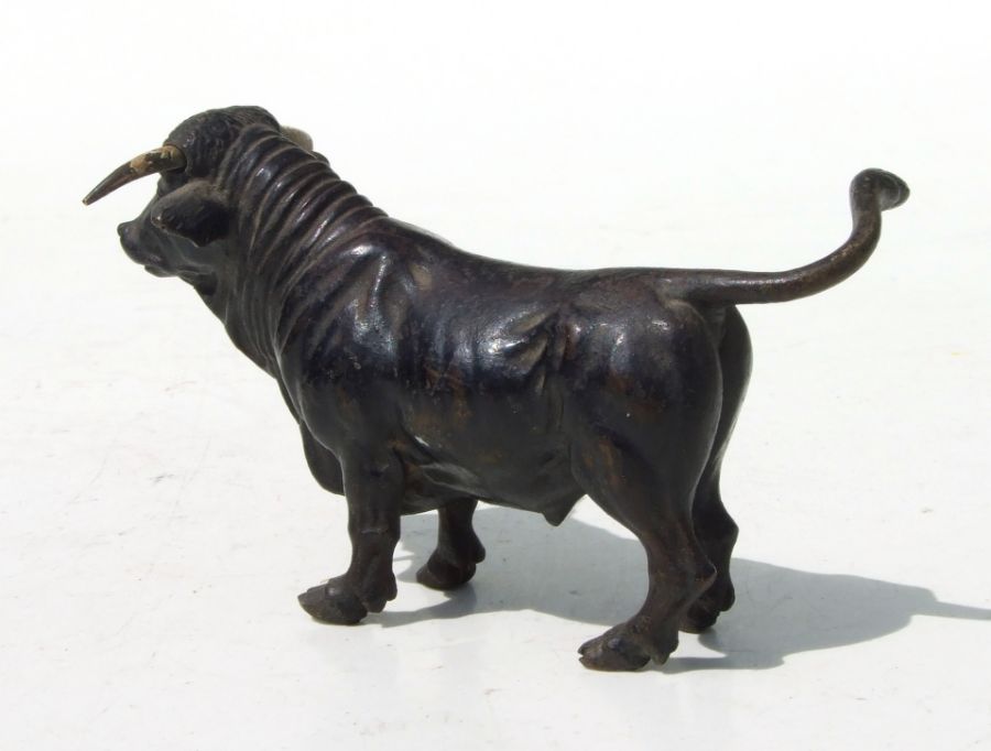 A cold painted bronze figure in the form of a standing bull, 10cms long. - Image 2 of 2