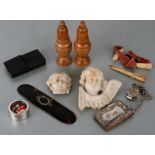 A pair of treen salt and peppers, a silver plated chatelaine notebook, two marble cherub plaques and