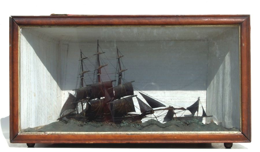 A cased diorama depicting three masted sailing ship at full sail, overall 89cm wide