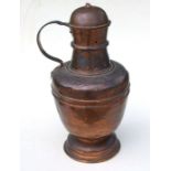 A large copper jug and cover, 57cms high.