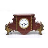 A 19th century rouge marble mantle clock with gilt spelter mounts, fitted with an 8-day movement,