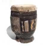 An African drum with carved decoration and animal hide skin, 30cms diameter.