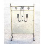 A late 19th century mirrored brass fire screen with applied rams head masks and swags, 48cm wide (