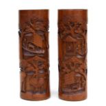 A pair of Chinese bamboo brush pots decorated with figures, birds and flowers, 35cms high.