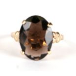 A 9ct gold dress ring set with a large oval smoky quartz, approx UK size 'P', 3.3g.
