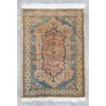 A modern Chinese style woollen rug with central multi coloured medallion, on a blue ground, 146 by