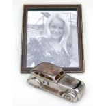 A chrome table top cigarette or match box in the form of a 1940's American Sedan, 20cms long;