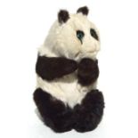 A vintage panda bear soft toy.