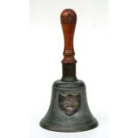 A Victorian hand bell with turned wooden handle and white metal presentation plaque 'This Bell was