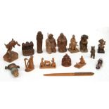 A group of carved wooden figures to include a Black Forest miniature bear and Anri bottle stopper.