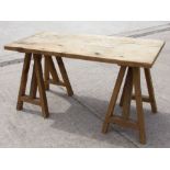 A modern pine trestle table, 140cms wide.