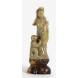 A Chinese soapstone carved group depicting Guanyin and her attendant, 20cms high.