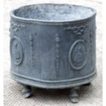 A lead garden planter of cylindrical form decorated with crinoline ladies in panels, on hoof feet,