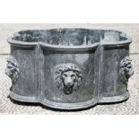 A lead garden planter of lobed form decorated with lion masks, 45.5cms diamter.Condition