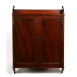 A mahogany two-door wall cupboard, 53cms wide.