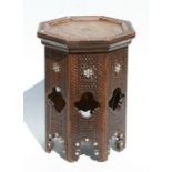 An Islamic / Moorish octagonal occasional table with mother of pearl inlay decoration, 28cms wide.