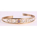 A 9ct gold bangle set with a single amethyst, 5.5g.