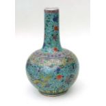 A large Chinese famille vert bottle vase decorated with dragons amongst foliate scrolls on a