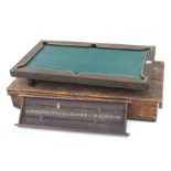 An early 20th century Nuku miniature billiard table, 51 by 28cms, with an associated scoreboard,