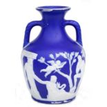 A Wedgwood Jasperware style Portland vase decorated with classical figures, 22cms high.