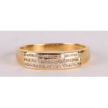 An 18ct gold ring set with three rows of diamonds, approx UK size 'N', 3.6g.