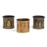 Three Islamic / Moorish brass and copper cylindrical mortars with inlaid decoration, each 7cms