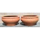 A pair of terracotta planters of compressed circular form, each 42cms diameter (2).