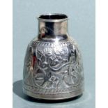 An Islamic / Moorish white metal vase with embossed decoration, 8cms high.