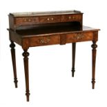 A 19th century figured walnut writing table, the galleried superstructure with short drawers, two
