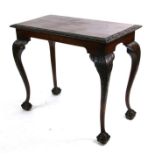 A George III style mahogany console table, the rectangular top with carved edge, on a shaped frieze,