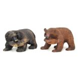 A Canadian carved wooden bear with a salmon in his mouth, 18cms long; together with another similar,