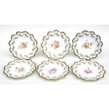 A set of six Royal Crown Derby dessert cabinet plates hand painted with sprays of flowers and gilt
