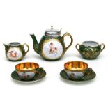 A late Victorian Austro Hungarian five-piece ceramic tea set with vignettes of hand painted cherubs,