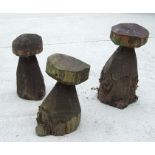 A group of three carved wooden mushrooms, the largest 65cms high (3).