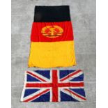 A Union Jack flag, 124 by 80cms wide; and a German Democratic Republic flag, 263 by 106cms (2).