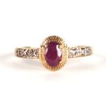 A 9ct gold dress ring with central oval pale red stone and diamond set shoulders, approx UK size '