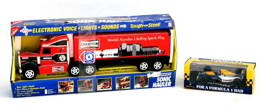 A Kenworth Sonic Hauler lorry with Champion advertising, 50cms long, boxed; and an Onyx 1:24 scale